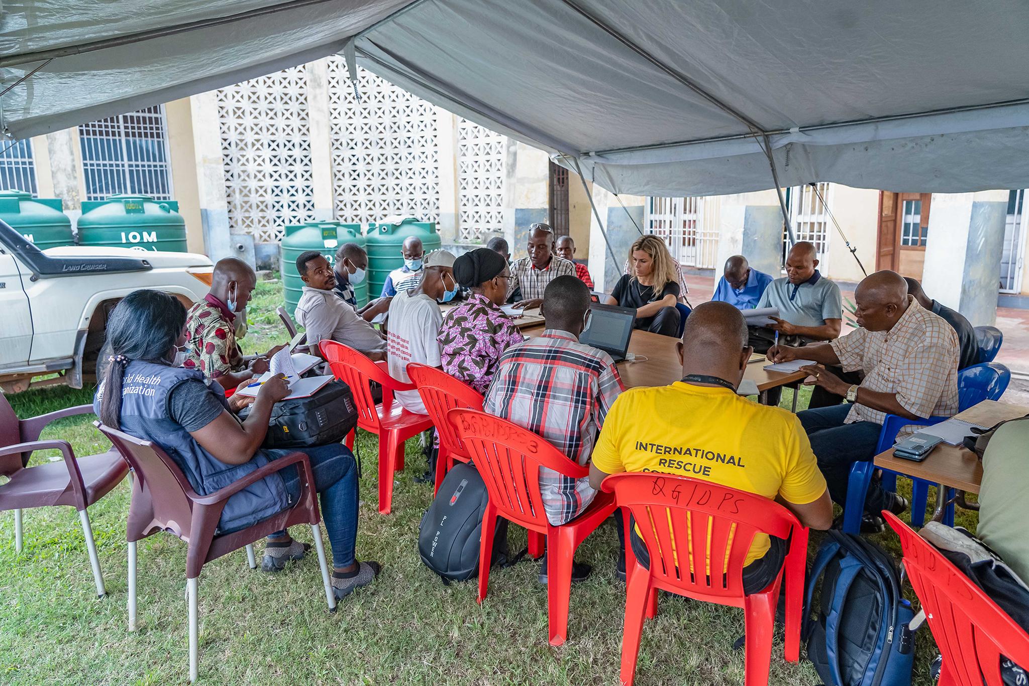 A group of people sitting in chairs A group of people sitting in chairs